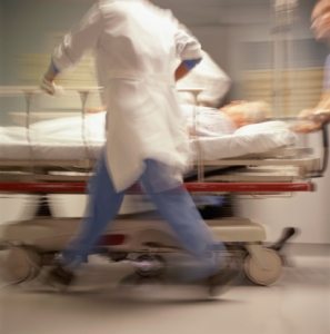 Doctors pushing patient on trolley (blurred motion)