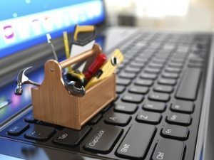 Online support. Toolbox with tools on laptop.